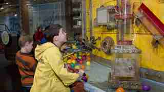 Children playing with water in the Idea Factory exhibit