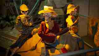Skeletons dressed like farmers playing instruments