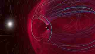 A graphic visualization of the magnetic field that surrounds Earth represented by many thin blue lines and red fog